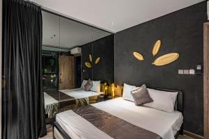 a bedroom with two beds and a wall with mirrors at Bonita Signature The View in Ho Chi Minh City