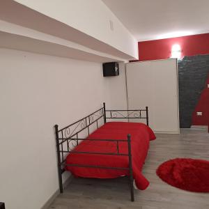 una camera con un letto rosso e una coperta rossa di suite Holiday House Bonaccorso a Catania