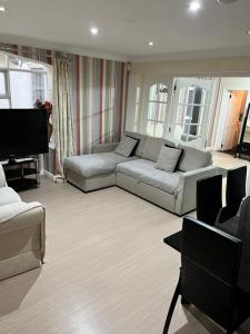 a living room with a couch and a television at On The Beach Apartments in Blackpool