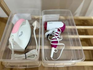 a clear plastic box with a hairdryer and a hair dryer at Infistay Homestay - Sunway Geo Avenue, Sunway Pyramid, Sunway Lagoon, Sunway University, Sunway Medical Centre in Subang Jaya