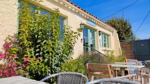 une table et des chaises devant une maison dans l'établissement Camping Tikayan Félix de la Bastide, à Saint-Mitre-les-Remparts