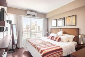 a bedroom with a bed and a large window at Quartier San Telmo Suites 10 in Buenos Aires +20 photos