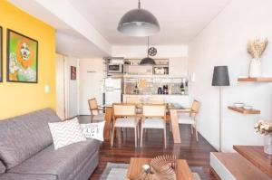 a living room with a couch and a table at Quartier San Telmo Suites 10 in Buenos Aires