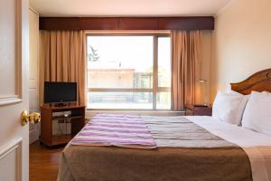 Letto o letti in una camera di MR Apart Providencia (ex Apart Neruda)