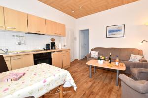 a kitchen and a living room with a table at Haus-Herrmann-1 in Borkum