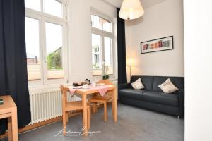 Gaestehaus-St-Josef-1 في بوركوم: غرفة معيشة مع طاولة وأريكة