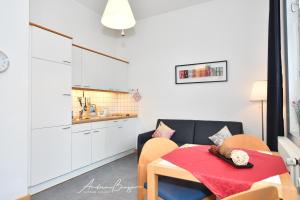 a small dining room with a table and a kitchen at Gaestehaus-St-Josef-2 in Borkum
