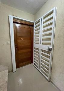 a door to a room with a wooden door at Three bedroom, two bath flat in San Isidro, Santo Domingo Este in Mendoza