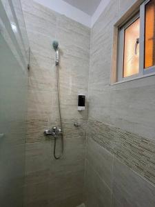 a bathroom with a shower with a glass door at Three bedroom, two bath flat in San Isidro, Santo Domingo Este in Mendoza