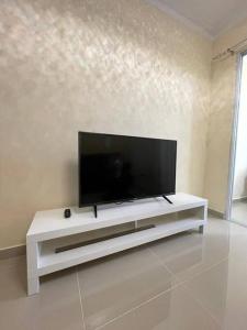 a flat screen tv sitting on top of a white entertainment center at Three bedroom, two bath flat in San Isidro, Santo Domingo Este in Mendoza