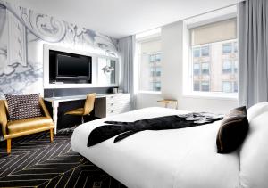 a hotel room with a bed and a tv at W Montreal in Montreal