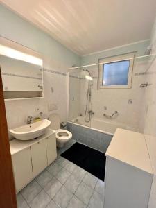 a bathroom with a sink and a toilet and a shower at Appartamento vacanze Sanzen - Como Cernobbio Lugano in Morbio Inferiore