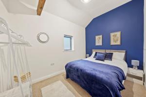 a blue and white bedroom with a bed and a window at Parking, Heated floors, Sleeps 4 guests, Netflix in Lincoln