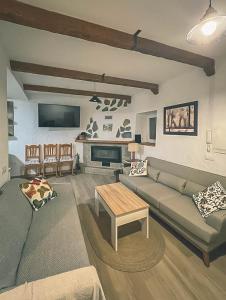 a living room with a couch and a table at Casa Rural El cerrillo in Abrucena