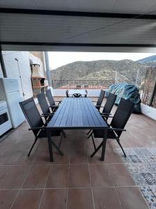 AbrucenaにあるCasa Rural El cerrilloの青いテーブルと椅子が備わるパティオ