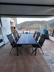 a blue table and chairs on a patio at Casa Rural El cerrillo in Abrucena