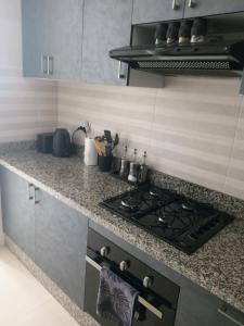 a kitchen with a stove and a counter top at home Lesieur in El Jadida