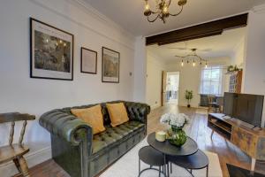 a living room with a couch and a table at 2 Bedroom Terrace House in Bedford by SILVA in Bedford