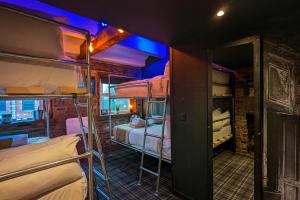 a room with two bunk beds and a room with a open door at Briggate Hotel in Leeds