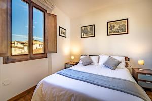 a bedroom with a large bed and a window at YID VELLUTINI in Florence