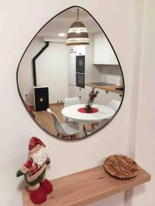 - un miroir rond suspendu sur un mur blanc dans le salon dans l'établissement A casiña de Luz, à Pontevedra