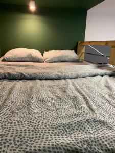 a large bed with two pillows on top of it at Apartament Wrocławska blisko zamku Książ in Wałbrzych