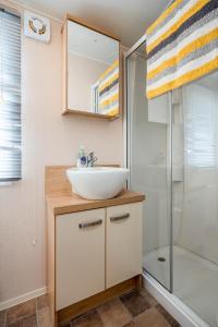 a bathroom with a sink and a shower at Lyons Retreat in Lossiemouth