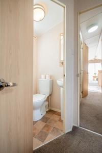 a bathroom with a toilet and a sink at Lyons Retreat in Lossiemouth