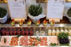 a display case with different types of meat and vegetables at Romantik Hotel Hirschen in Parsberg