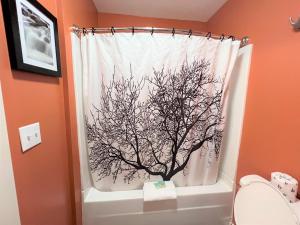 a shower curtain with a tree on it in a bathroom at Mountain Top Inn and Resort in Warm Springs
