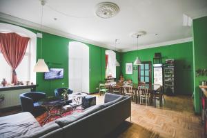 a living room with green walls and a couch at Hostel Jamaika in Vilnius