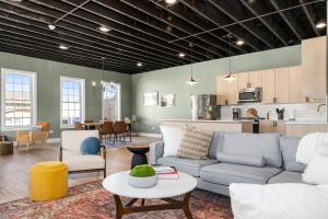 a living room with a couch and chairs and a kitchen at Richmond No. 267 in Richmond