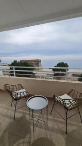 two chairs and a table on a balcony with a view at Moraira Beach in Moraira