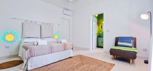 a bedroom with a bed and a chair at Villa Paliceddi - Torre Pali in Torre Pali 