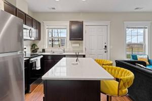 a kitchen with a refrigerator and a counter top at Stylish and Comfortable 1-BR in the Heart of Detroit in Detroit +25 photos