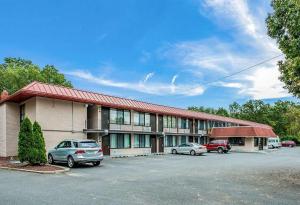 a building with cars parked in a parking lot at Red Carpet Inn & Suites NJ-73 in Hammonton