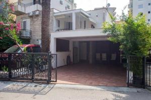 a house with a gate and a driveway at Splendid Luxury Apartments in Budva