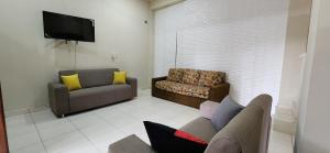 a living room with a couch and a chair at Casa duplex en Área 4 CDE in Ciudad del Este