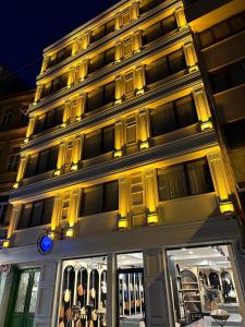 a lit up building with a store front at night at Casa De Port Hotel İstanbul in Istanbul