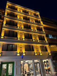 a tall building with yellow lights on top of it at Casa De Port Hotel İstanbul in Istanbul