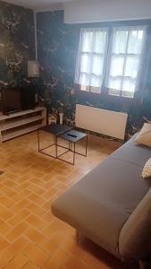uma sala de estar com uma cama e uma mesa de centro em Petite maison ploufragan em Ploufragan