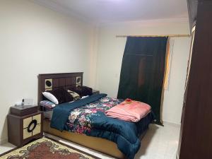 a small bedroom with a bed and a window at Gardenia city cairo in Cairo