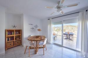 a dining room with a table and chairs and a balcony at La Casa del Sur in San José