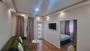 a living room with a couch and a bed at Medjugorje Apartments Centre in Međugorje