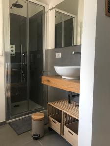 a bathroom with a sink and a glass shower at Nuances del Conero Relais in Castelfidardo +18 photos