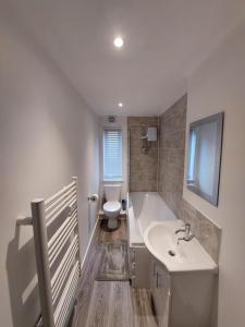 a bathroom with a white sink and a toilet at Apartment Balmoral Road in Northampton