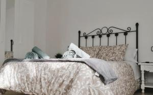 a bedroom with a bed with a gray and white comforter at Sueños de Córdoba in Córdoba