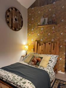 a bedroom with a bed with a bird wallpaper at Siedlisko Farmhouse in Okszów