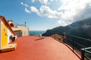 a balcony of a house with a view of the ocean at Amalfi Coast Donna Carmela Apartment Pontone holiday house in Scala