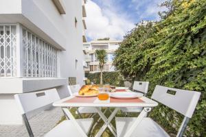a table and chairs on the balcony of a building at FishermenApartments - Carcavelos 1 in Carcavelos